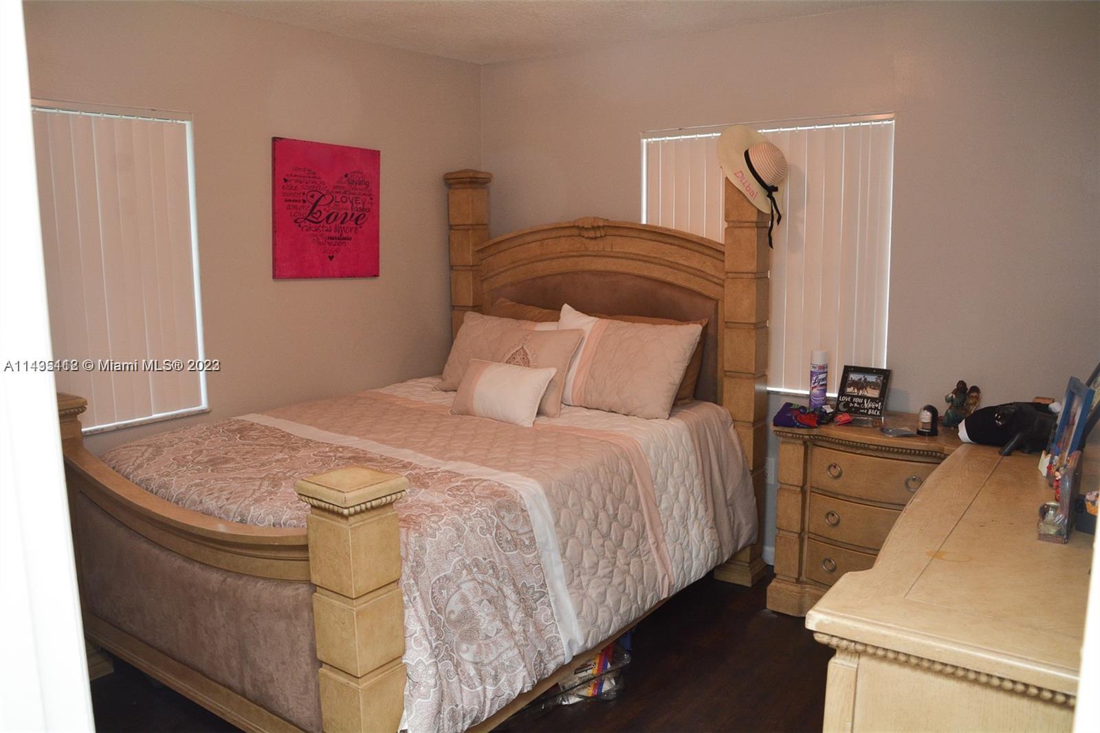 1990 Southwest 103rd Terrace Miramar, FL 33025 - Photo 15 of 19 a bedroom with a bed and a dresser