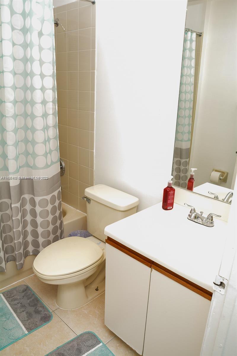 1990 Southwest 103rd Terrace Miramar, FL 33025 - Photo 16 of 19 a white toilet sitting next to a bathroom sink and a shower