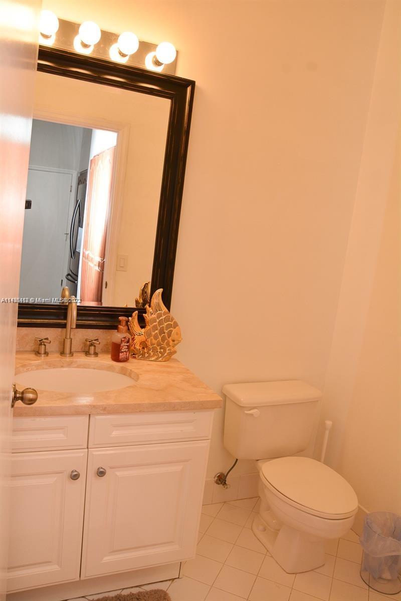 1990 Southwest 103rd Terrace Miramar, FL 33025 - Photo 18 of 19 a bathroom with a toilet sink and mirror