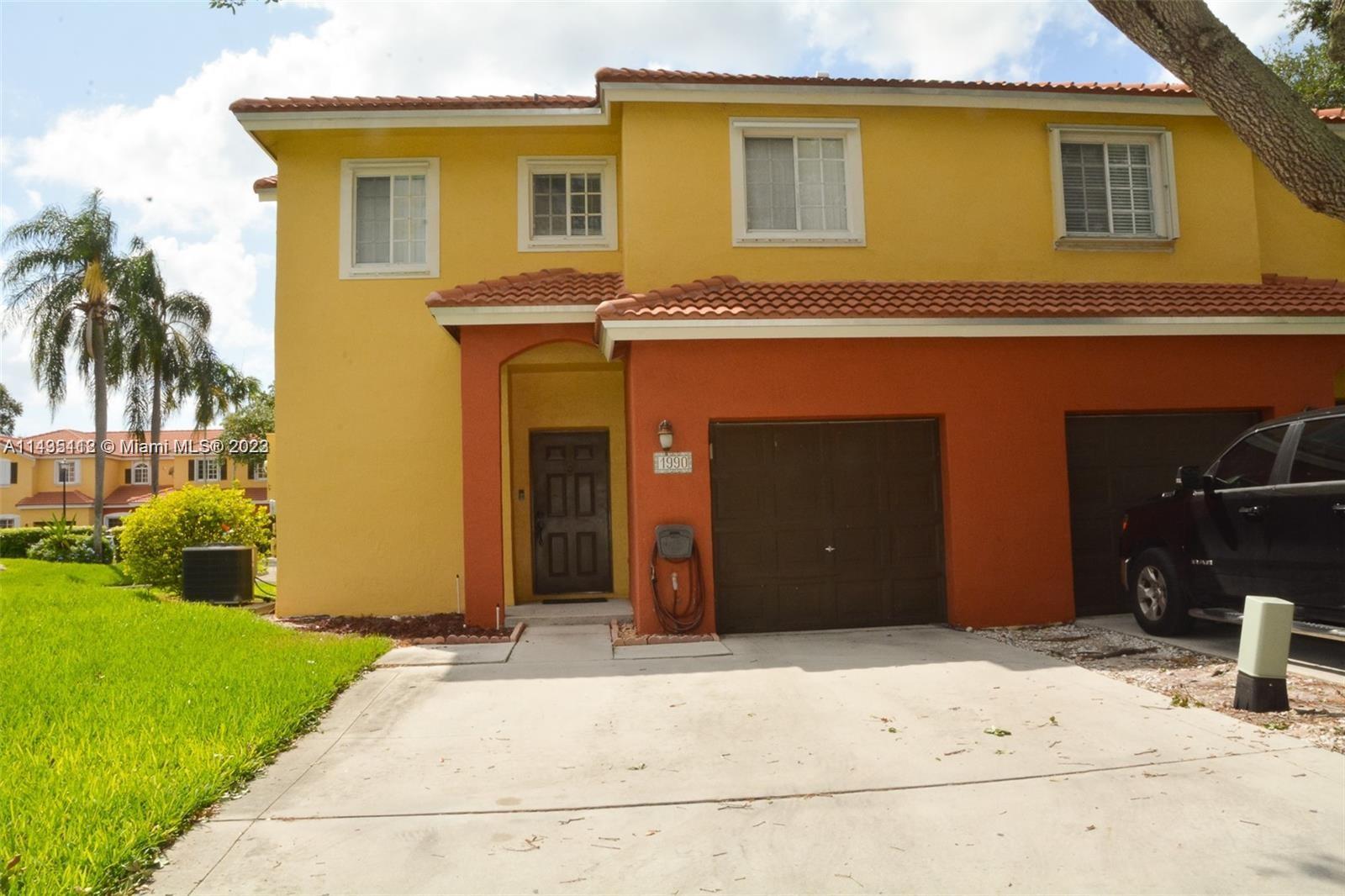 1990 Southwest 103rd Terrace Miramar, FL 33025 - Photo 2 of 19 a front view of a house with a yard