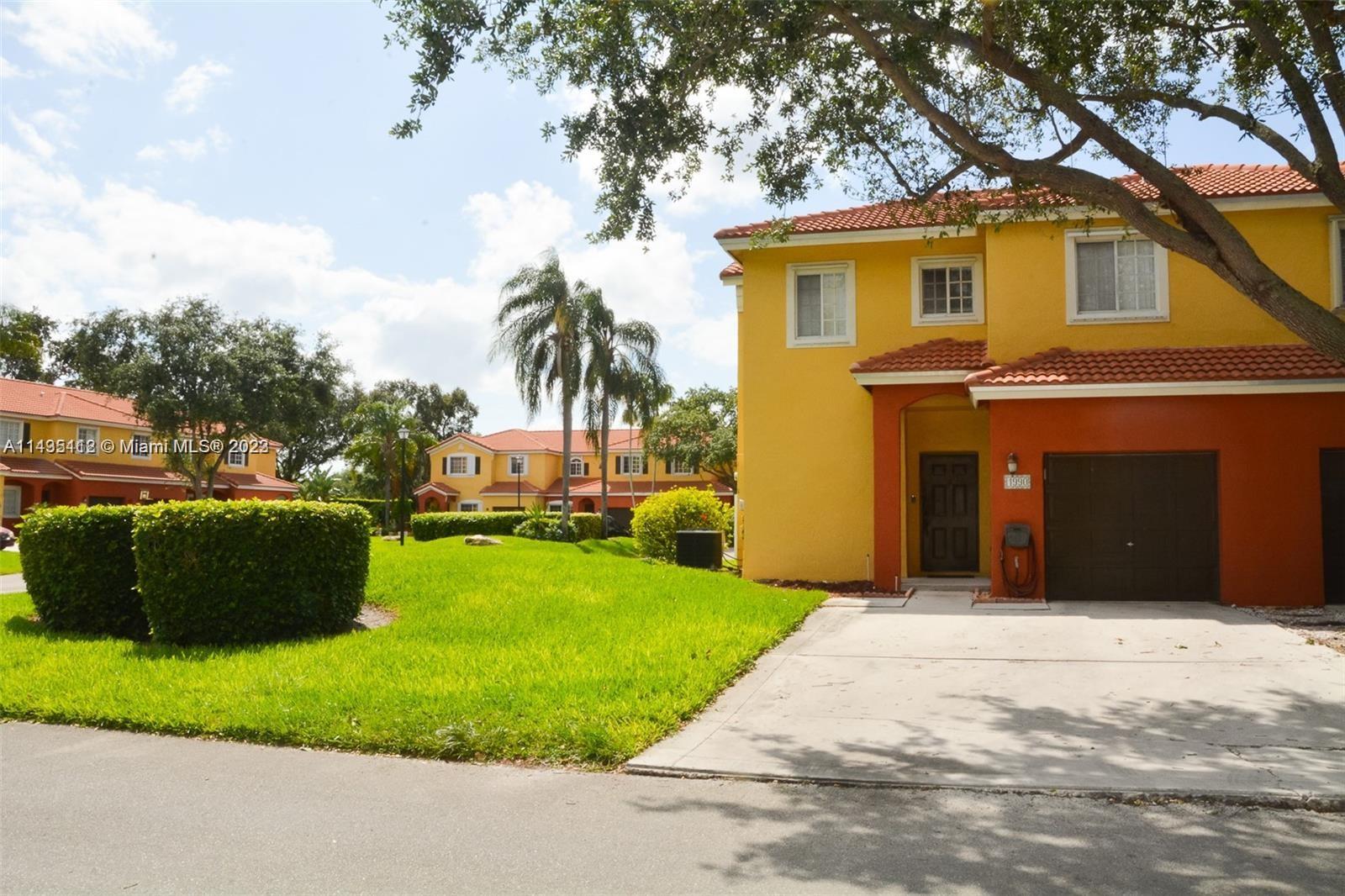 1990 Southwest 103rd Terrace Miramar, FL 33025 - Photo 3 of 19 a front view of a house with a garden and yard