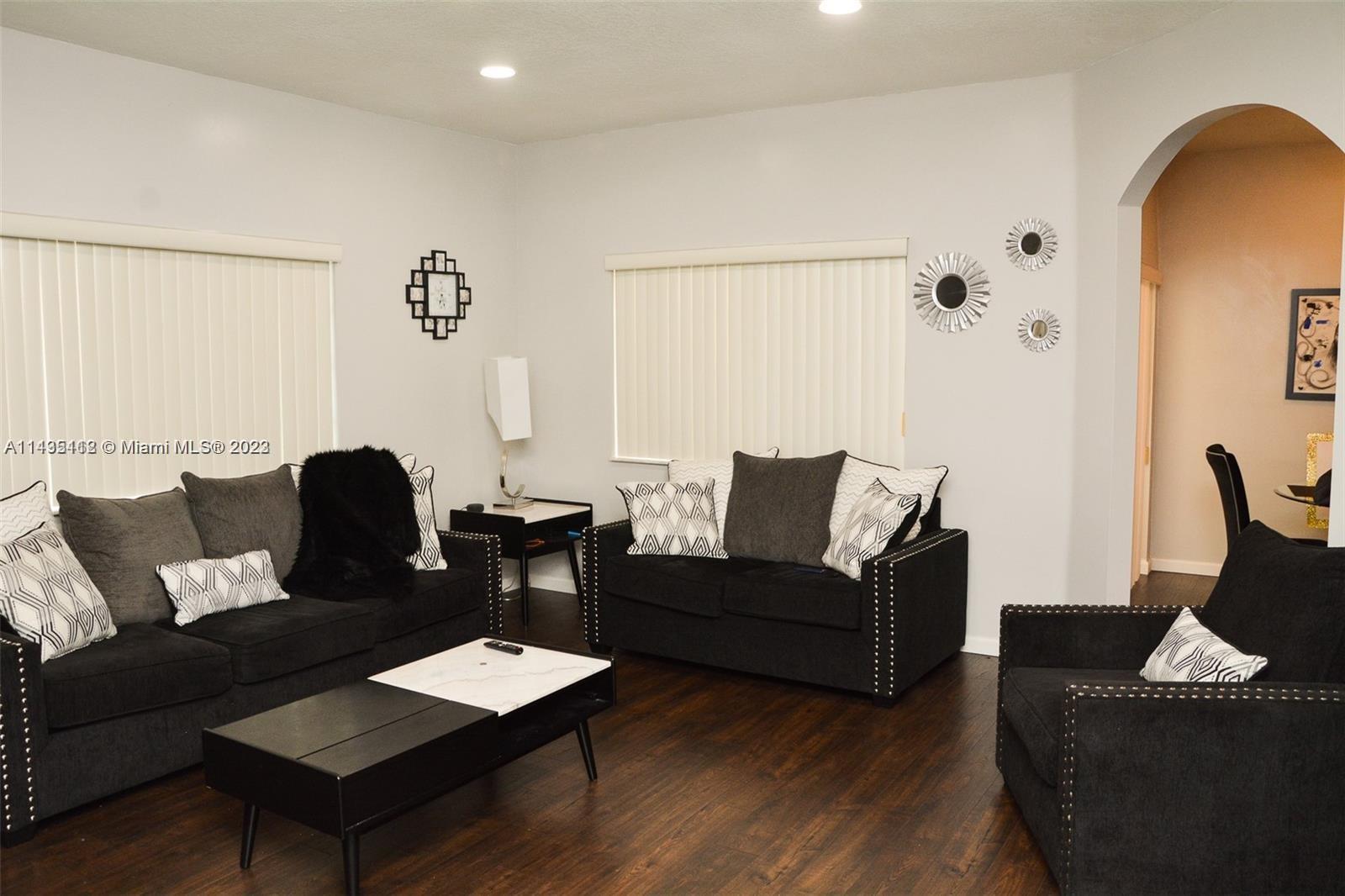 1990 Southwest 103rd Terrace Miramar, FL 33025 - Photo 6 of 19 a living room with furniture and a wooden floor