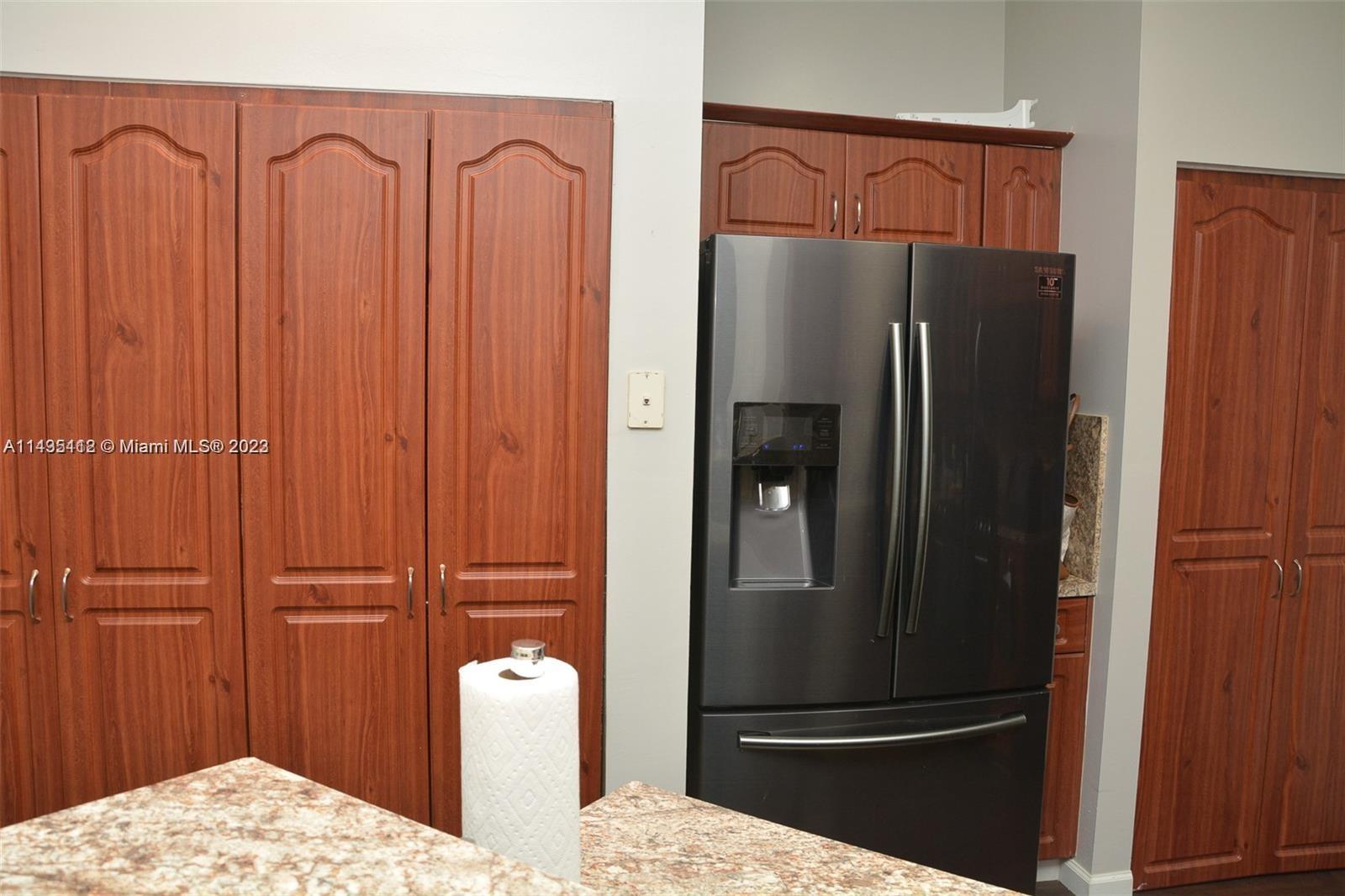 1990 Southwest 103rd Terrace Miramar, FL 33025 - Photo 9 of 19 a kitchen with metallic refrigerator freezer and a granite counter