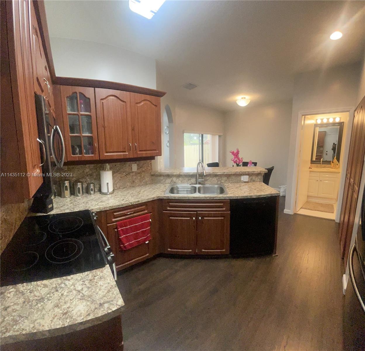1990 Southwest 103rd Terrace Miramar, FL 33025 - Photo 10 of 19 a kitchen with a sink stove and cabinets