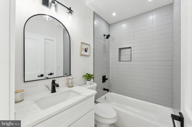 a bathroom with a sink a toilet and a bathtub