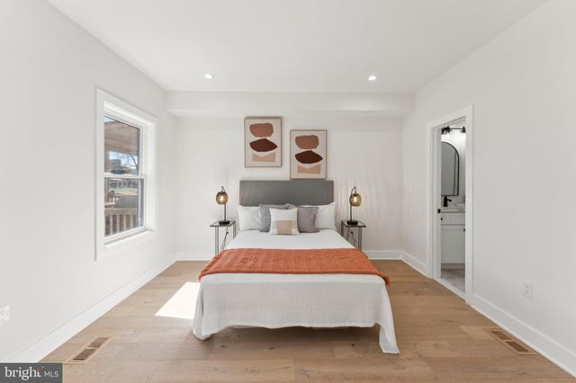 a bedroom with a large bed and a window