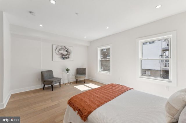 a bedroom with a bed and a chair