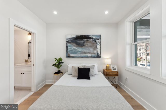 a hallway with a couch and a potted plant