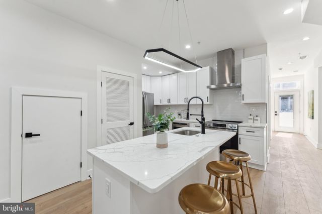 a kitchen with stainless steel appliances a sink and a refrigerator
