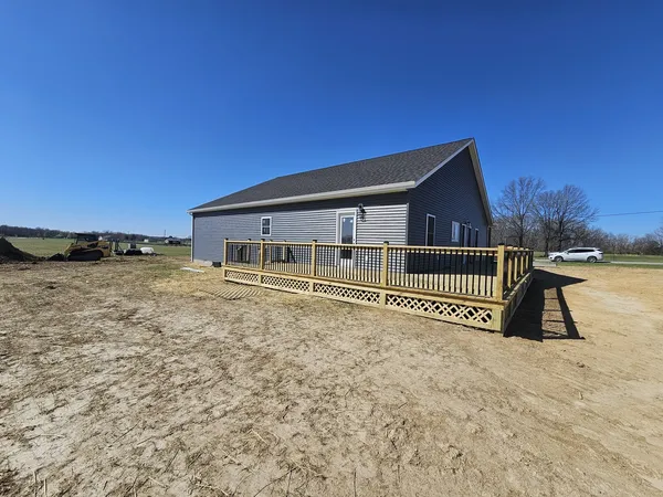 a view of a house with a wooden deck