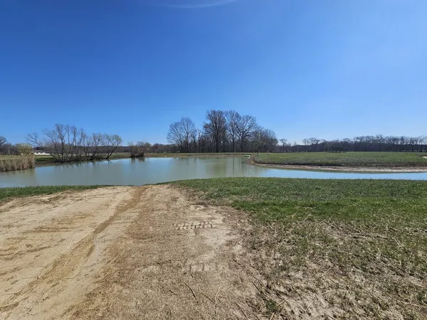 a view of a lake with houses in the background