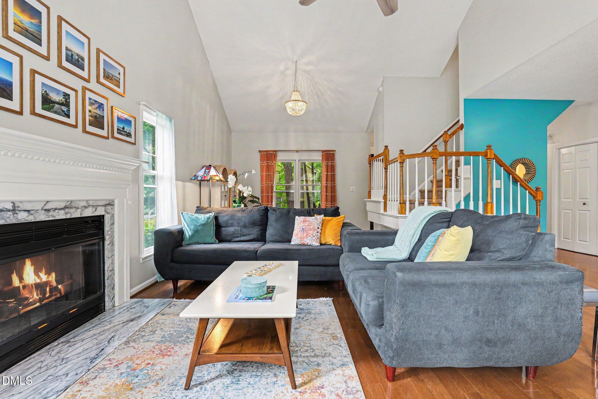 5468 Ingate Way Raleigh, NC 27613 - Photo 11 of 24 a living room with fireplace furniture and a rug