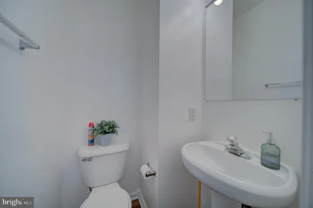 a white toilet sitting next to a white sink