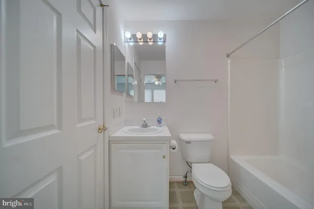 a bathroom with a toilet a sink and bathtub