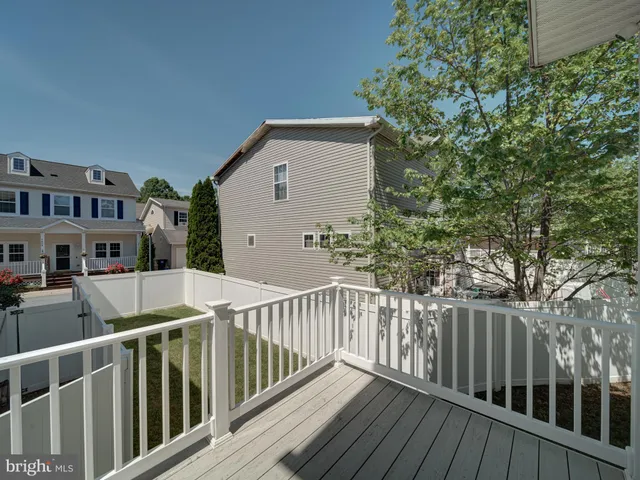 a view of a wooden fence and trees