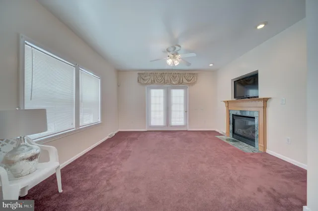 a view of empty room with a fireplace