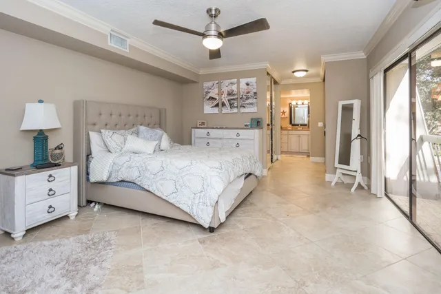 a spacious bedroom with a bed and a window