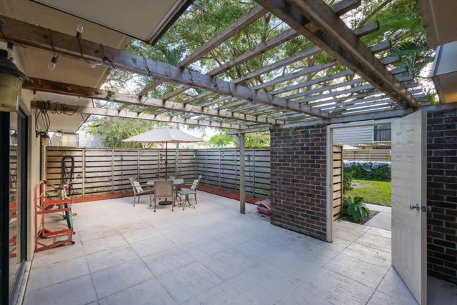 a view of a patio with table and chairs and potted plants