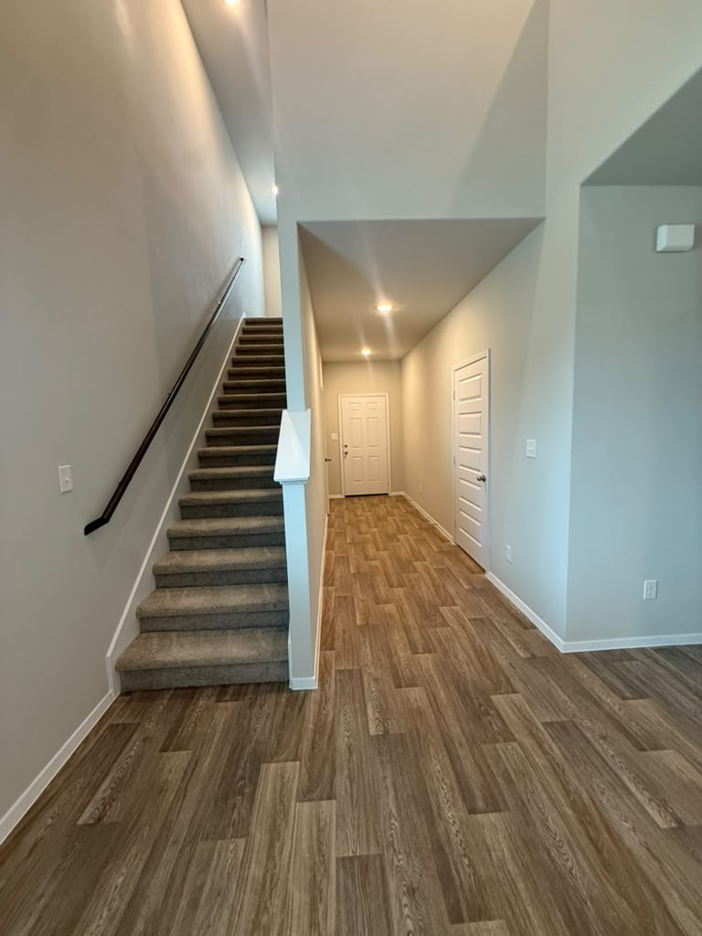 2601 Foss Road Manor, TX 78653 - Photo 14 of 40 Warm wood-look flooring and soaring ceilings welcome visitors into a bright, airy entryway.