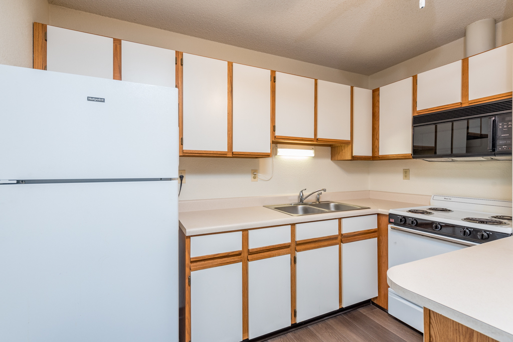 3305 Sunset Avenue, Unit 217 Waukegan, IL 60087 - Photo 4 of 17 a kitchen with stainless steel appliances granite countertop a sink a stove and a refrigerator