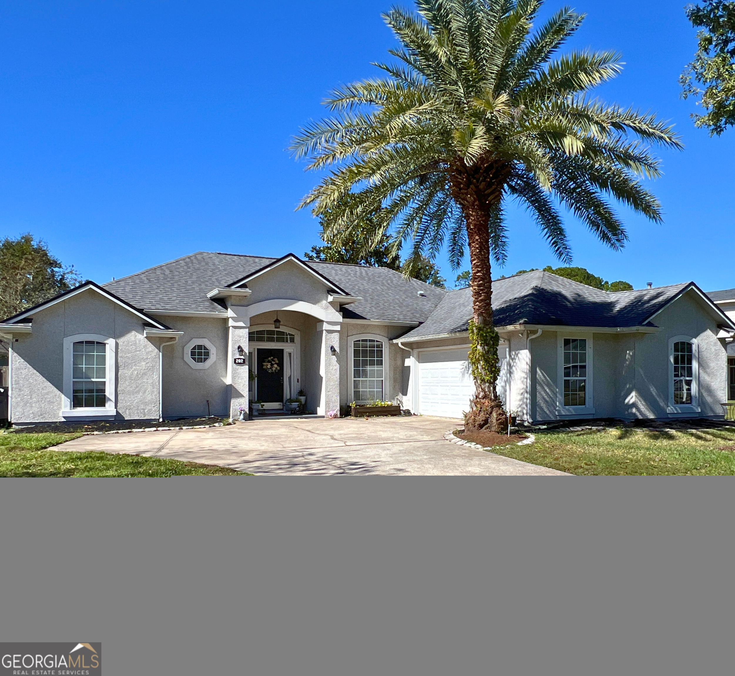 202 Bent Tree Court St. Marys, GA 31558 - Photo 1 of 25 a yellow house with trees in front of it