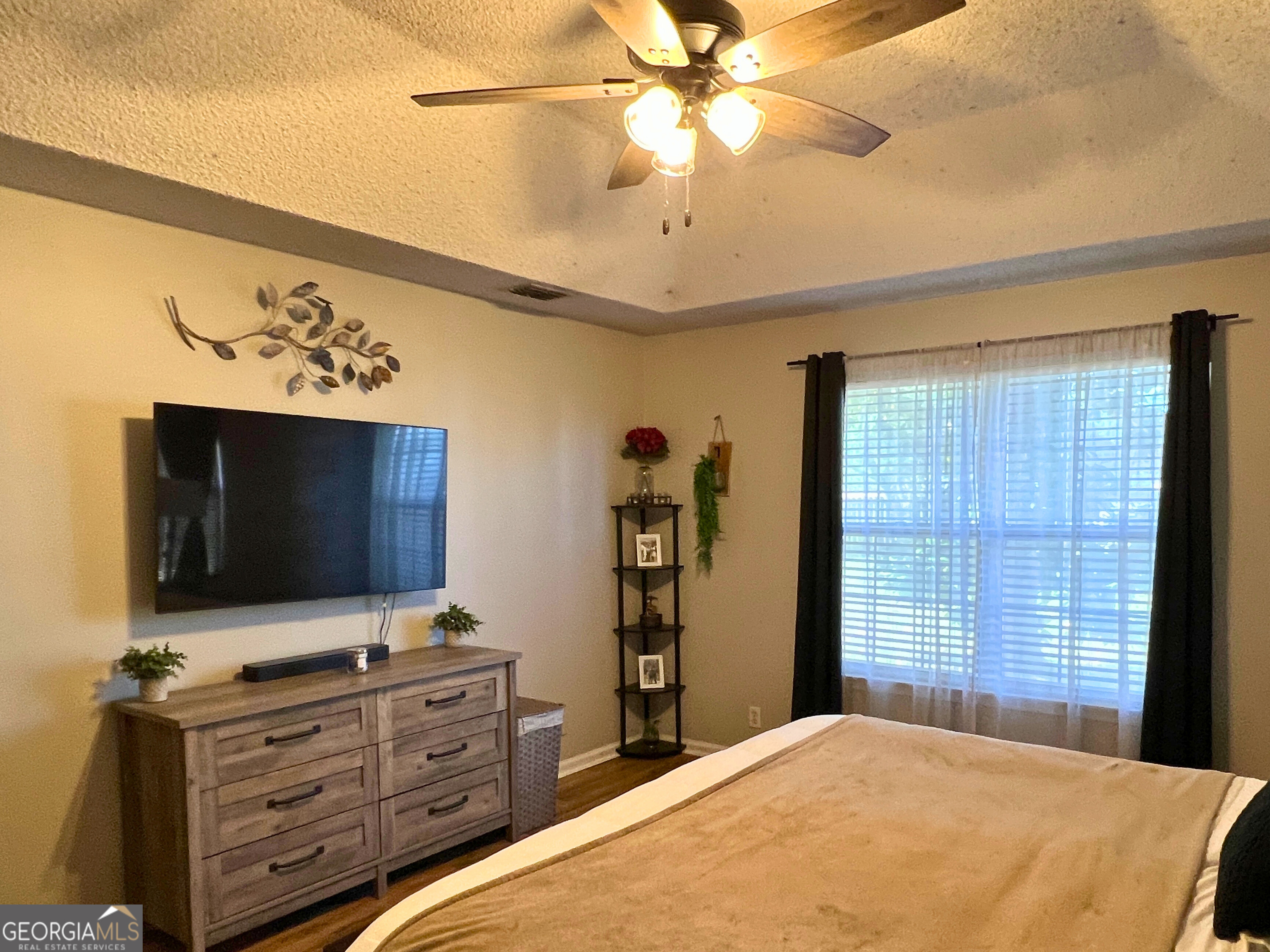 202 Bent Tree Court St. Marys, GA 31558 - Photo 13 of 25 a bedroom with a bed and a flat screen tv