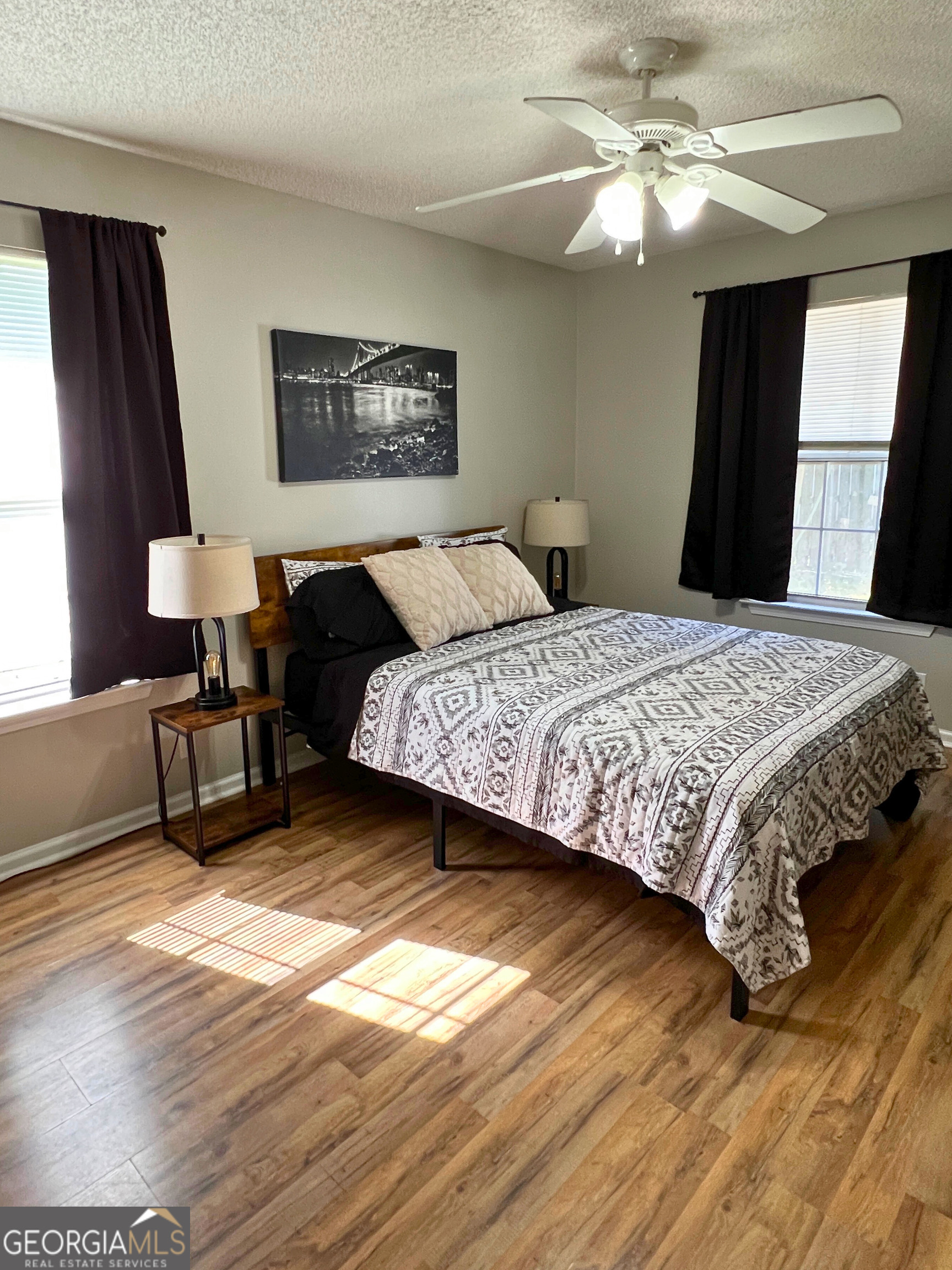 202 Bent Tree Court St. Marys, GA 31558 - Photo 21 of 25 a bedroom with a bed and a chandelier
