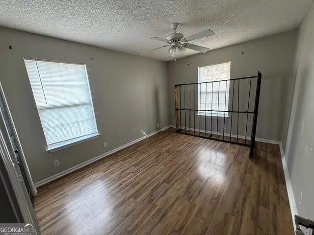 a view of a hallway view with wooden floor and staircase