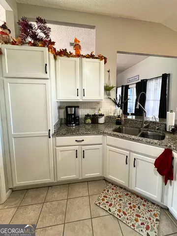 a kitchen with a refrigerator and a sink