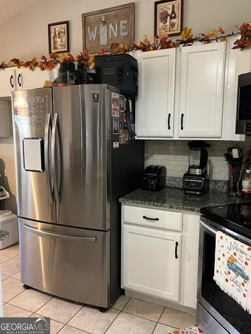 a kitchen with a refrigerator and cabinets