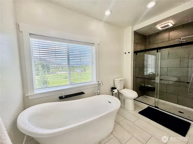 a bathroom with a tub and shower