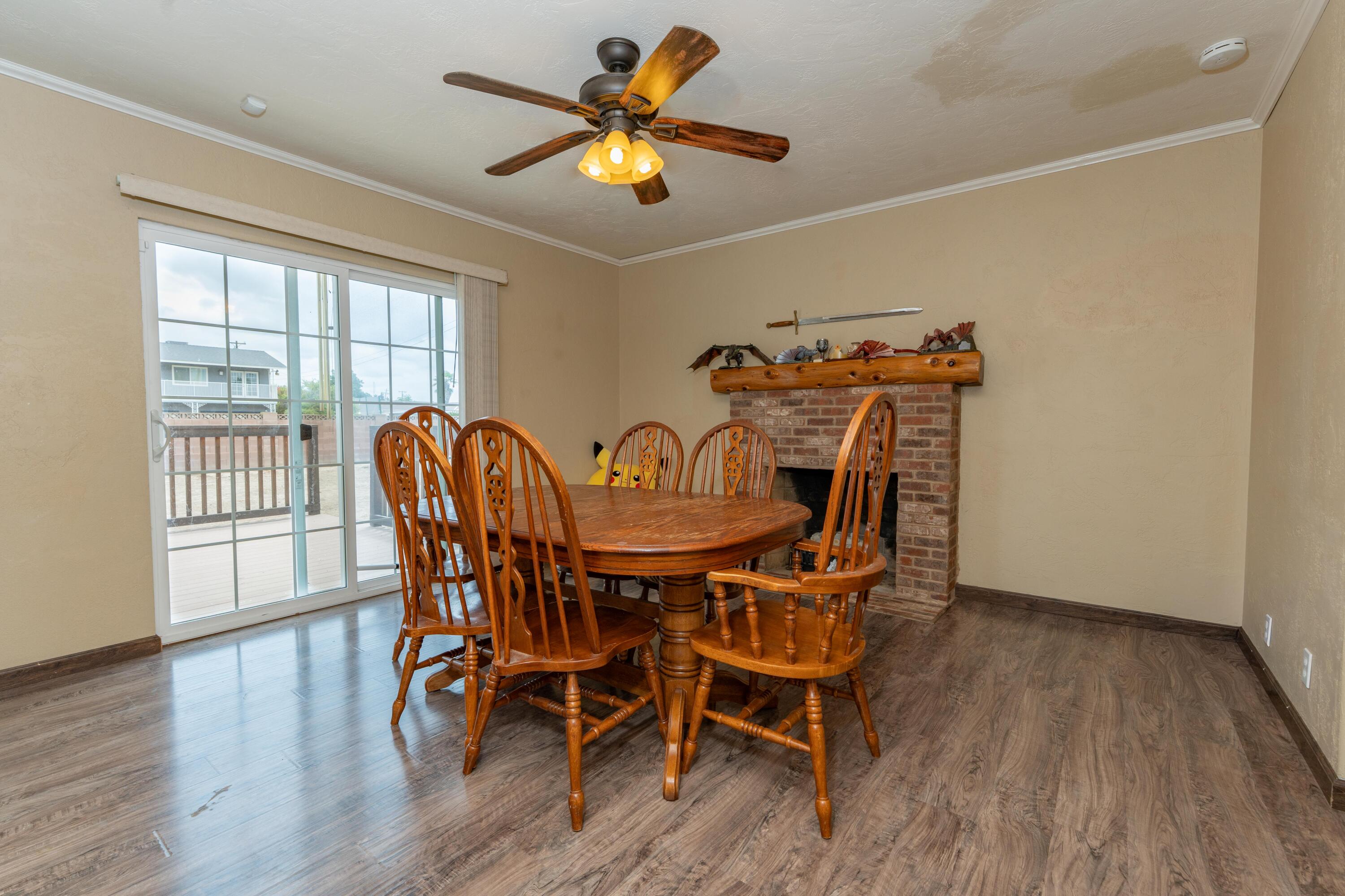 570 North Birch Avenue Reedley, CA 93654 - Photo 20 of 52 a view of a dining room with furniture a chandelier and wooden floor