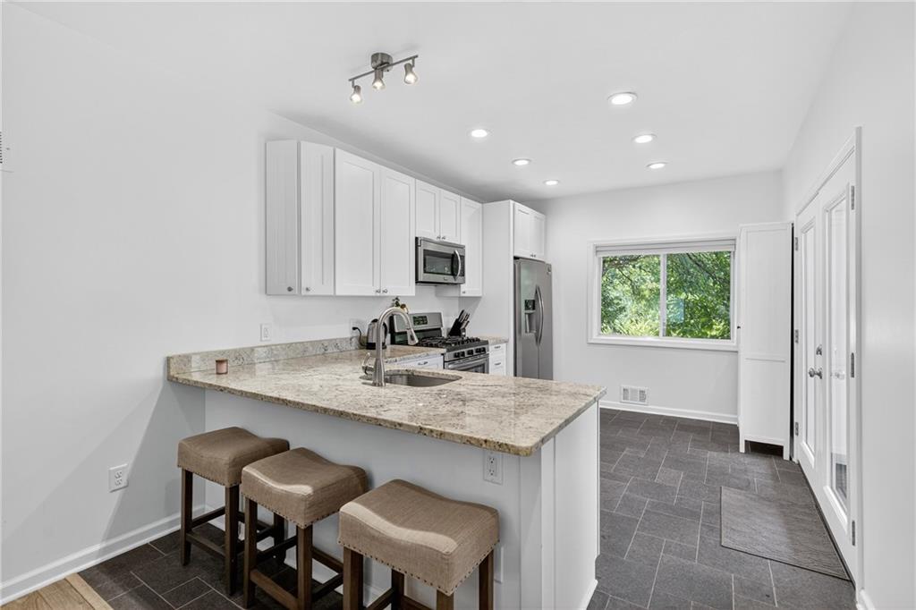 4536 Friendship Avenue Pittsburgh, PA 15224 - Photo 12 of 38 a view of kitchen island with furniture wooden floor and window