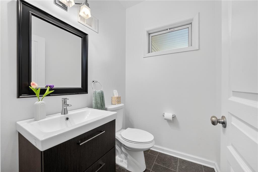 4536 Friendship Avenue Pittsburgh, PA 15224 - Photo 17 of 38 a bathroom with a toilet sink and mirror