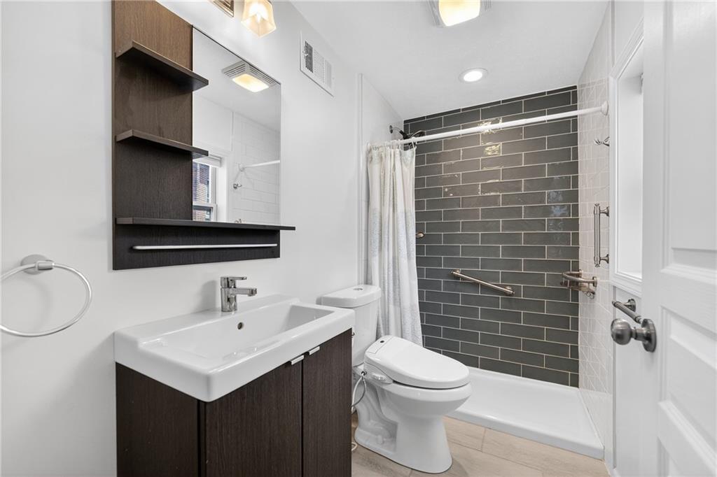 4536 Friendship Avenue Pittsburgh, PA 15224 - Photo 21 of 38 a bathroom with a sink toilet and shower