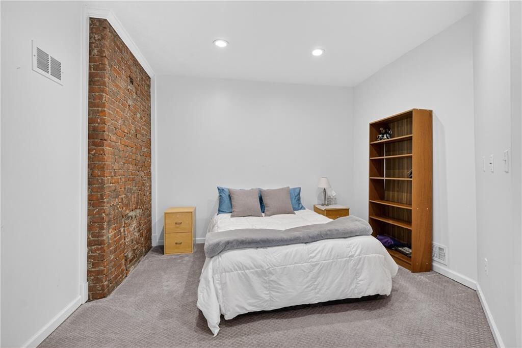 4536 Friendship Avenue Pittsburgh, PA 15224 - Photo 22 of 38 a bedroom with a bed and a walk in closet