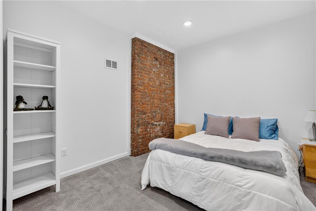 4536 Friendship Avenue Pittsburgh, PA 15224 - Photo 23 of 38 a bedroom with a bed and a walk in closet