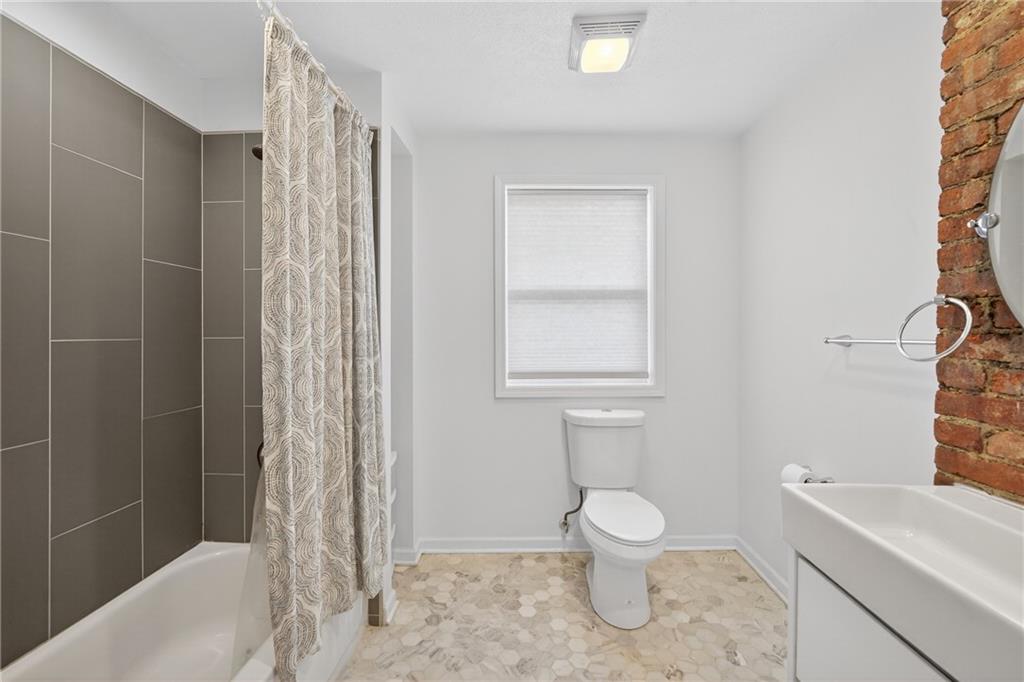 4536 Friendship Avenue Pittsburgh, PA 15224 - Photo 26 of 38 a bathroom with a toilet a sink and a shower