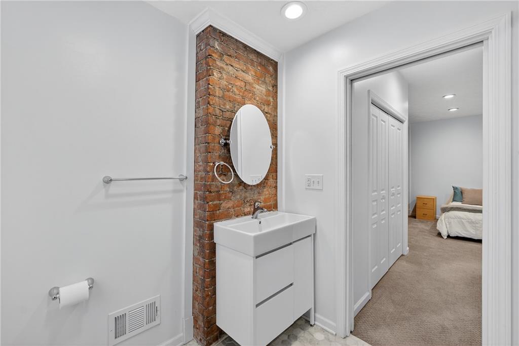 4536 Friendship Avenue Pittsburgh, PA 15224 - Photo 27 of 38 a room with a mirror and a wooden floor