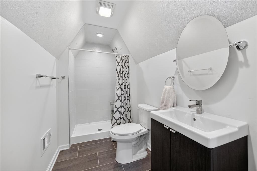 4536 Friendship Avenue Pittsburgh, PA 15224 - Photo 31 of 38 a bathroom with a sink toilet and shower