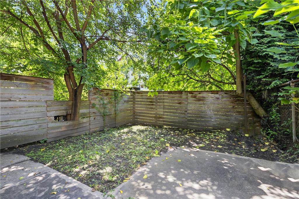 4536 Friendship Avenue Pittsburgh, PA 15224 - Photo 33 of 38 a view of a yard with plants and a large tree