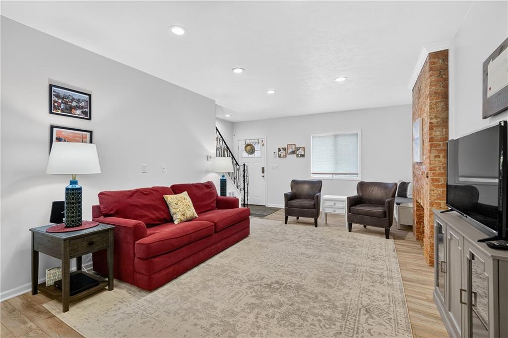 4536 Friendship Avenue Pittsburgh, PA 15224 - Photo 6 of 38 a living room with furniture and a flat screen tv