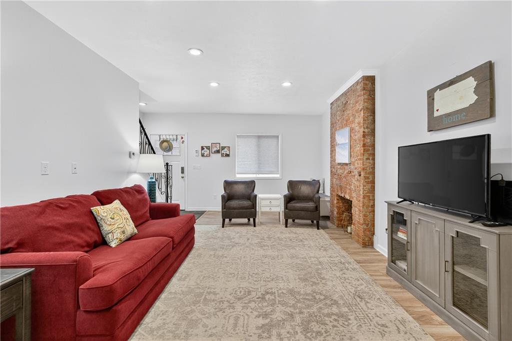 4536 Friendship Avenue Pittsburgh, PA 15224 - Photo 7 of 38 a living room with furniture and a flat screen tv