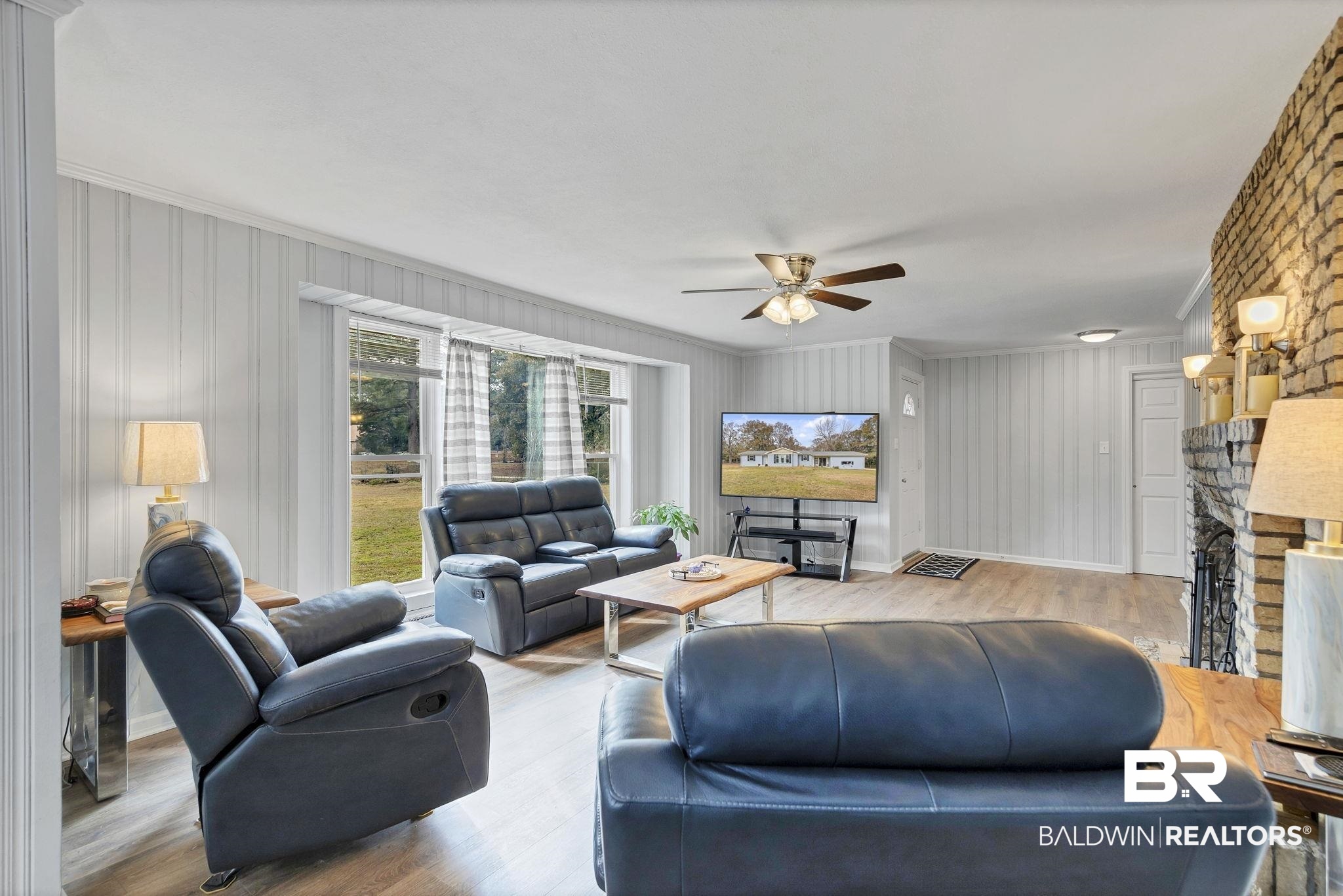 4690 Lott Road Eight Mile, AL 36613 - Photo 14 of 45 Living room featuring a brick fireplace, crown molding, light hardwood / wood-style floors, and ceiling fan