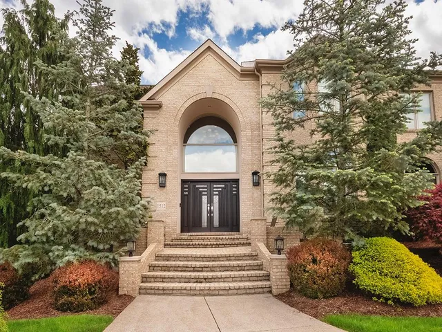 a front view of a house with a garden