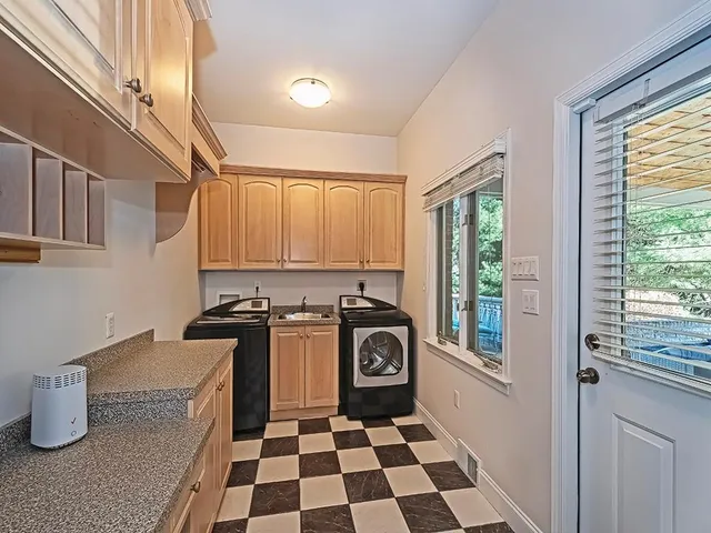 a kitchen with a stove a sink and a window
