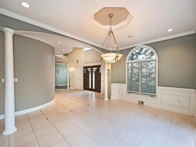 a view of an empty room with a chandelier
