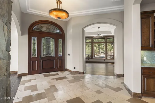 a kitchen with stainless steel appliances granite countertop a table and chairs in it