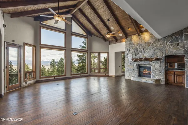 a bedroom with a large bed and a potted plant
