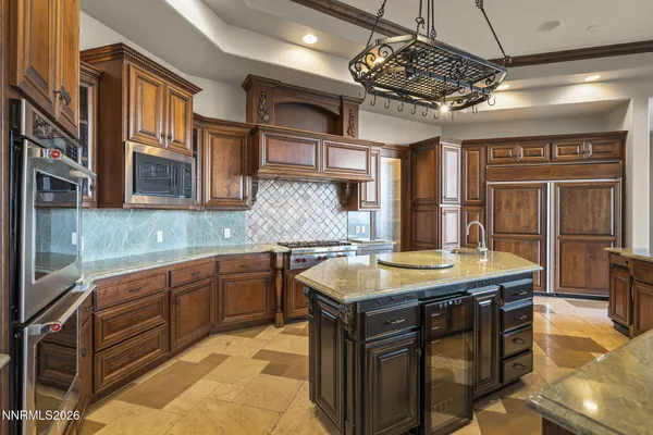 a view of a patio with a table and chairs under an umbrella